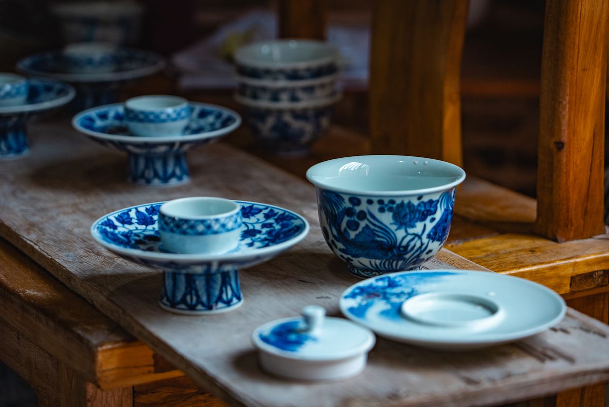 Hand-painted Arita porcelain cups on display in a showroom
