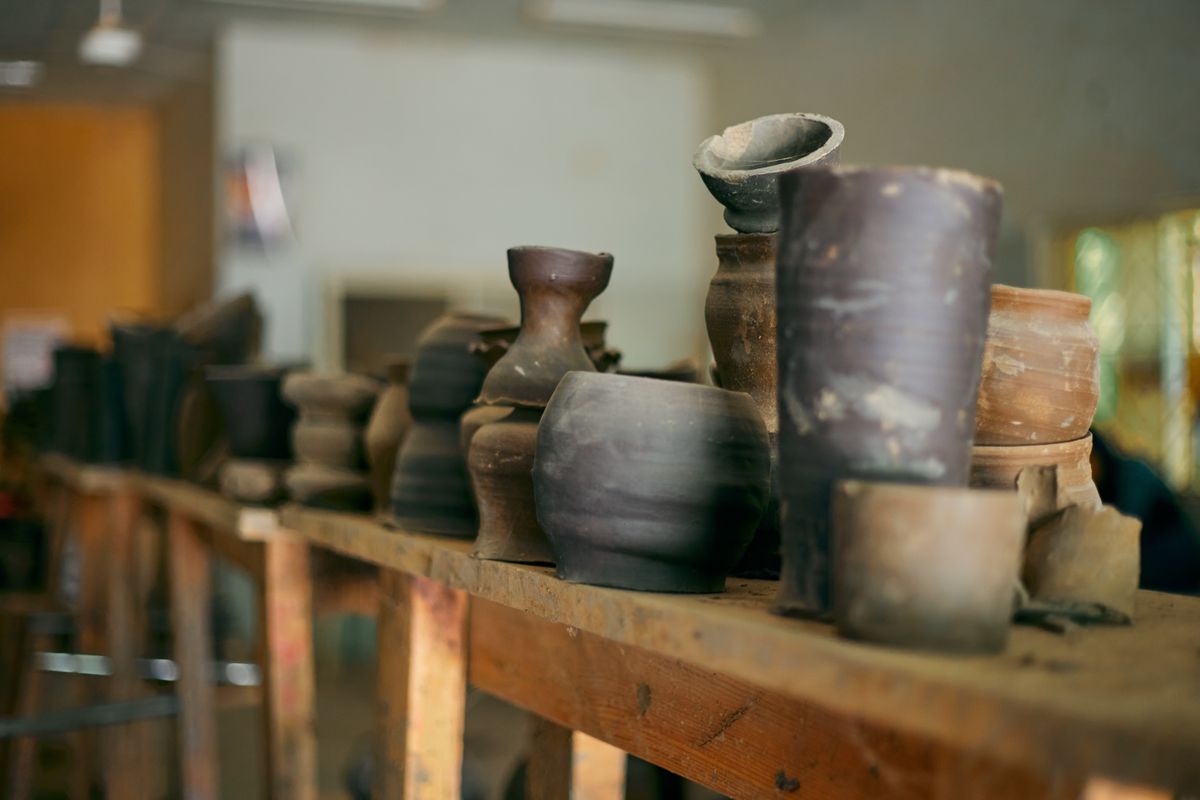Dark unglazed Bizen ware vessels on a potter's workbench