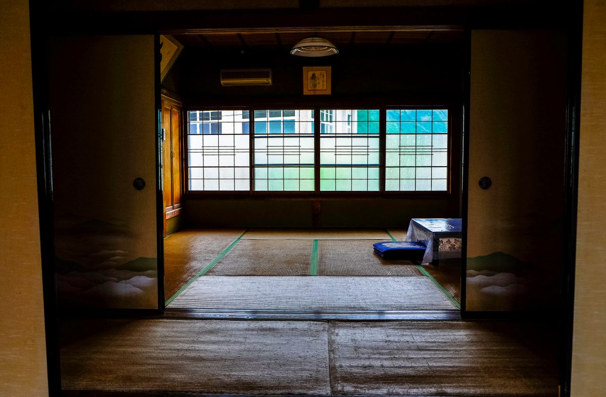 A plain tatami room with sliding doors open to the light, in a pilgrim lodge
