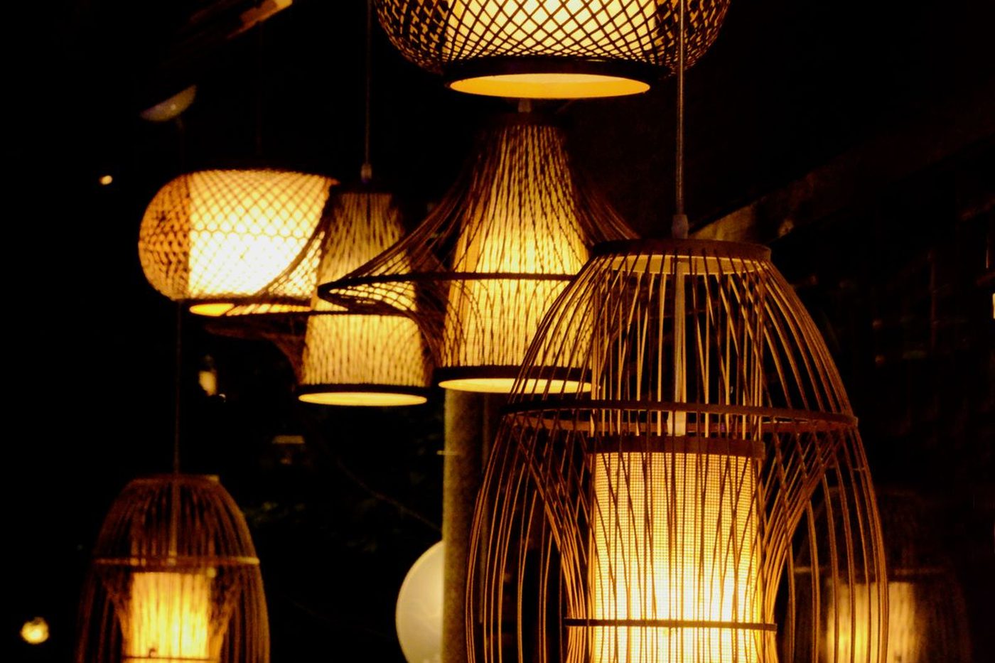 Woven bamboo lanterns glowing warm against the dark at Kurokawa Onsen