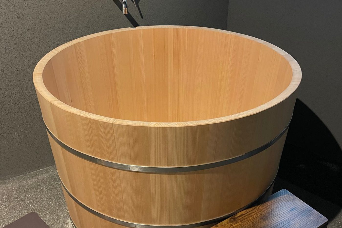 A round hinoki cypress soaking tub in a Kurokawa Onsen bathhouse
