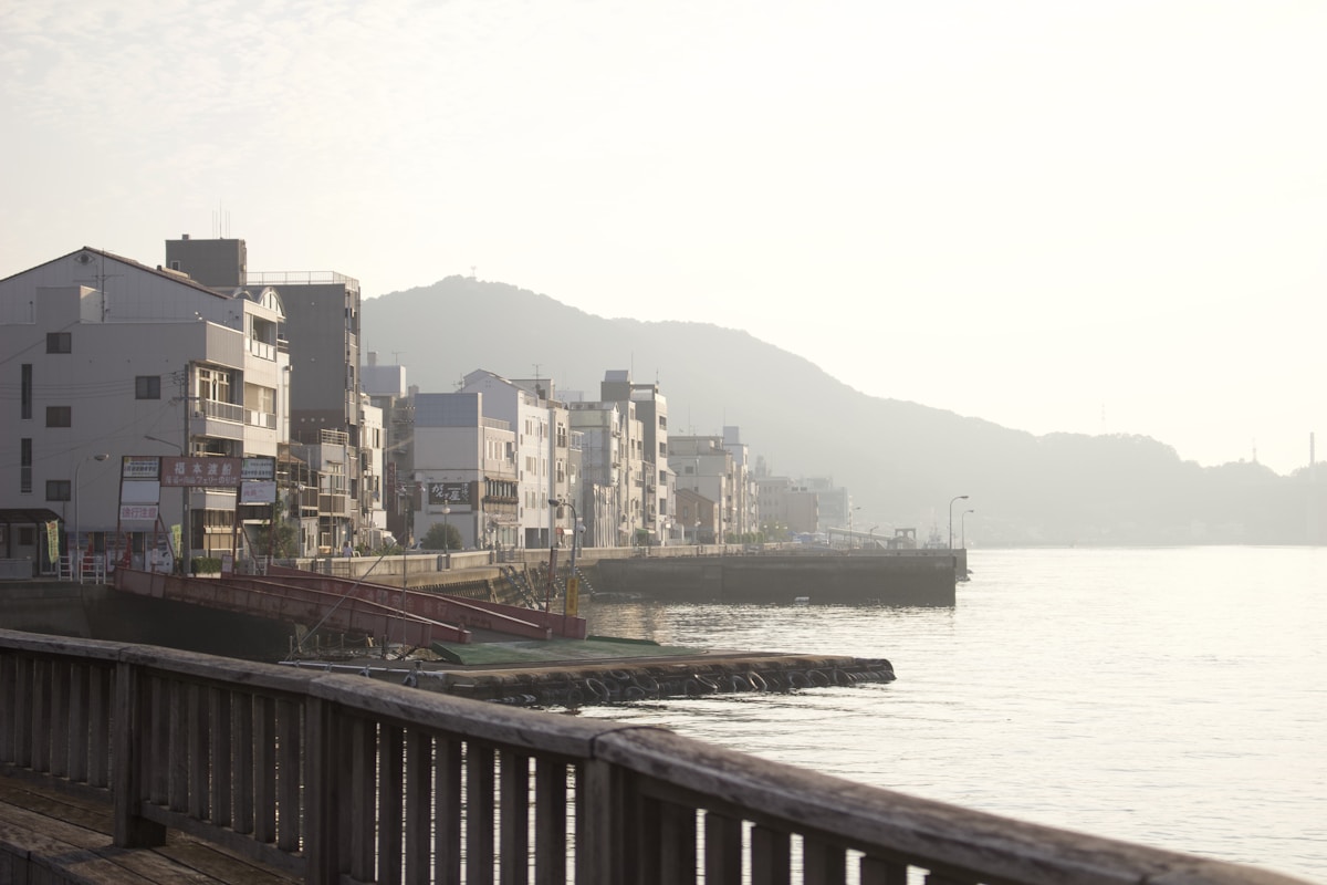 Onomichi's waterfront at dusk, with Mt. Senkoji rising behind the buildings